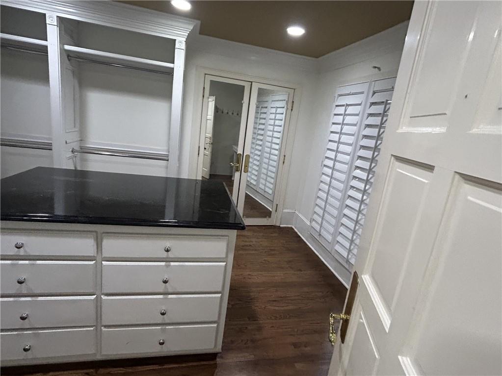 13039 Freemanville Road Alpharetta, GA 30004 - Photo 16 of 28 a view of an empty room with wooden floor and staircase