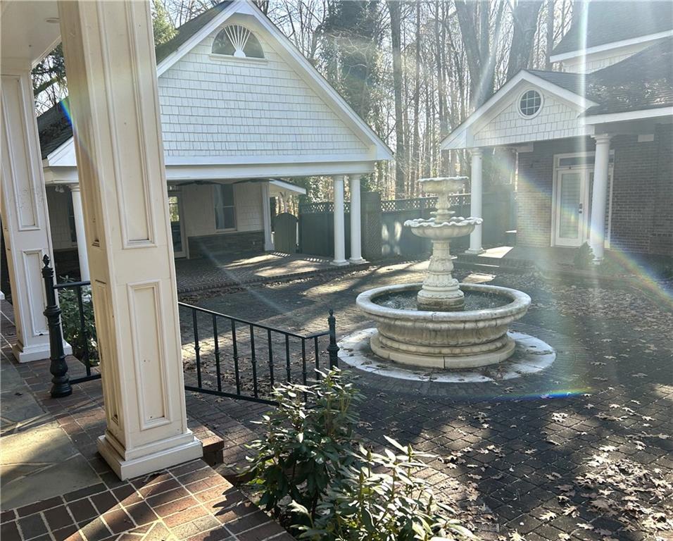 13039 Freemanville Road Alpharetta, GA 30004 - Photo 18 of 28 a front view of a house with a fountain and a fountain