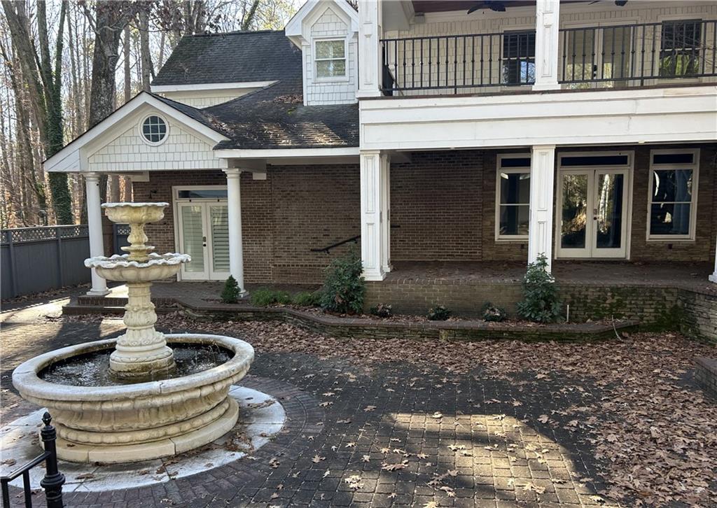 13039 Freemanville Road Alpharetta, GA 30004 - Photo 19 of 28 a front view of a house with garden and patio