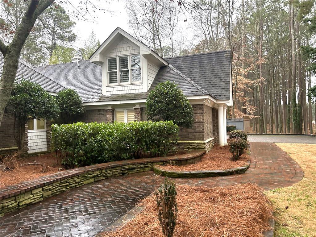 13039 Freemanville Road Alpharetta, GA 30004 - Photo 2 of 28 a front view of a house with garden