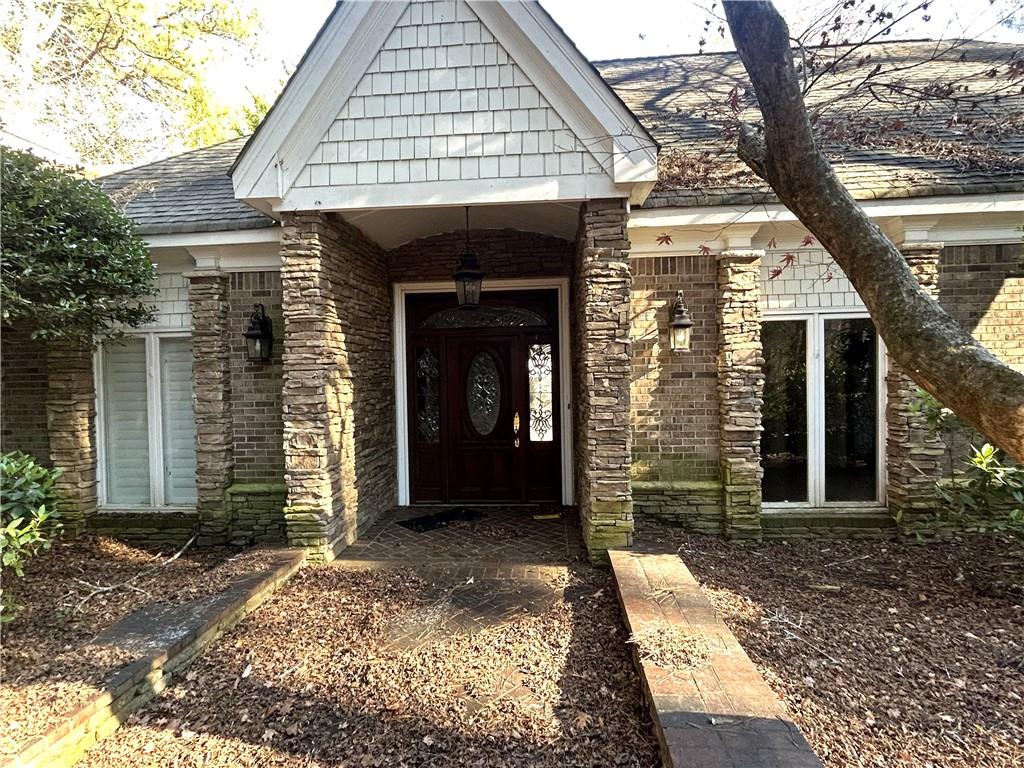 13039 Freemanville Road Alpharetta, GA 30004 - Photo 3 of 28 a front view of a house with a yard