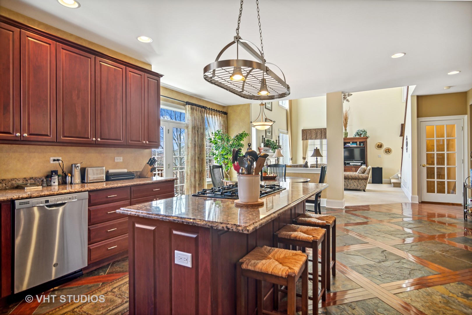 1015 Ridgeview Drive Inverness, IL 60010 - Photo 6 of 29 a kitchen with a refrigerator a stove a sink dishwasher with a dining table and chairs with wooden floor