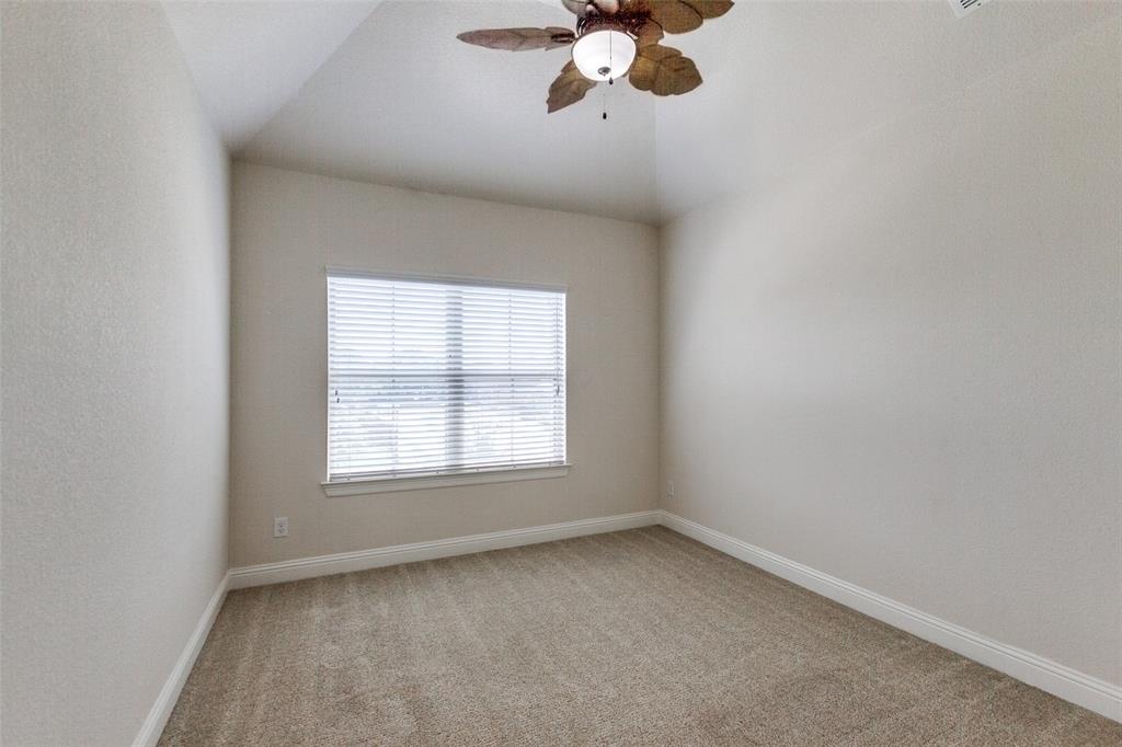 12618 Akenside Road Frisco, TX 75035 - Photo 17 of 31 Empty room featuring ceiling fan, vaulted ceiling, and light carpet