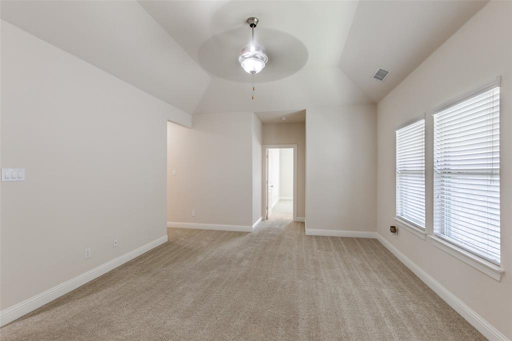 12618 Akenside Road Frisco, TX 75035 - Photo 18 of 31 Carpeted spare room with ceiling fan and vaulted ceiling