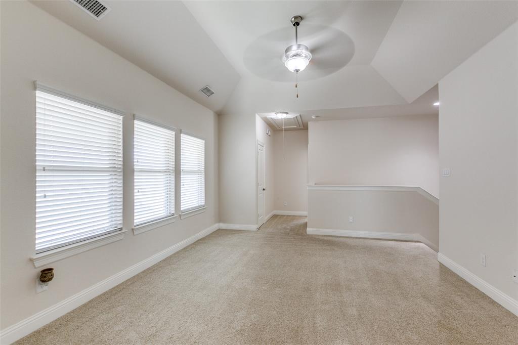 12618 Akenside Road Frisco, TX 75035 - Photo 19 of 31 Carpeted spare room with ceiling fan, a raised ceiling, and vaulted ceiling