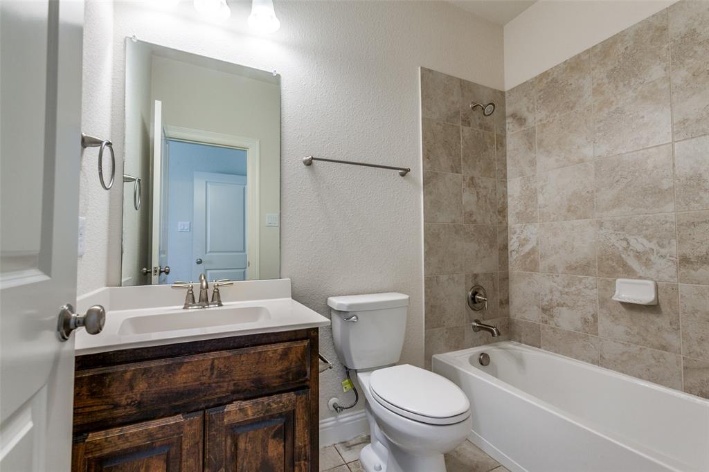 12618 Akenside Road Frisco, TX 75035 - Photo 20 of 31 Full bathroom featuring tile patterned flooring, toilet, tiled shower / bath, and vanity