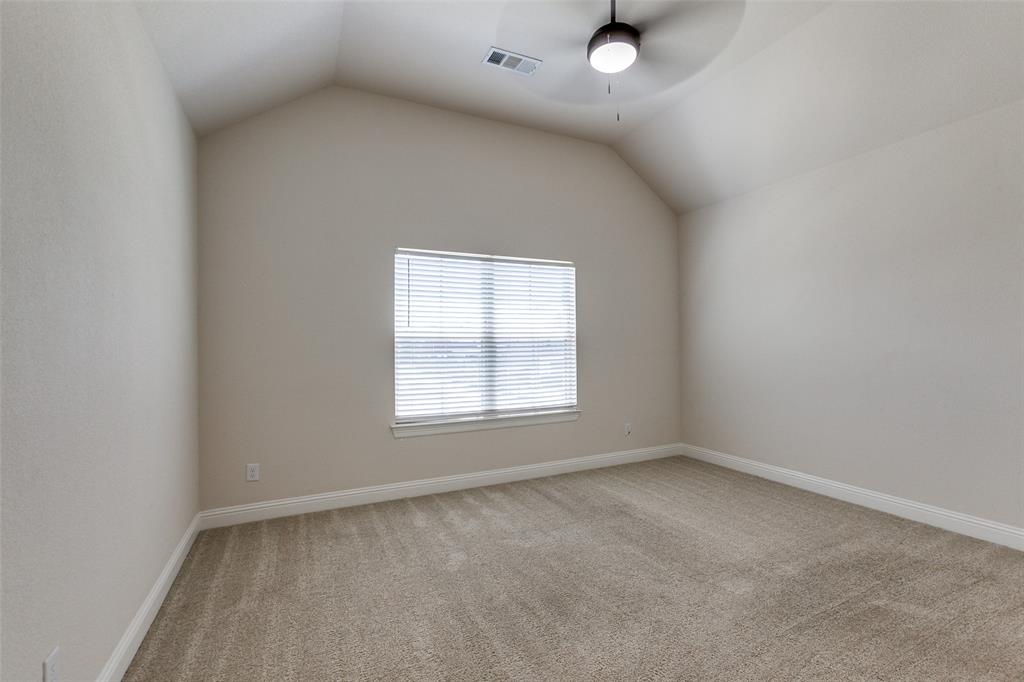 12618 Akenside Road Frisco, TX 75035 - Photo 21 of 31 Carpeted empty room featuring ceiling fan and vaulted ceiling
