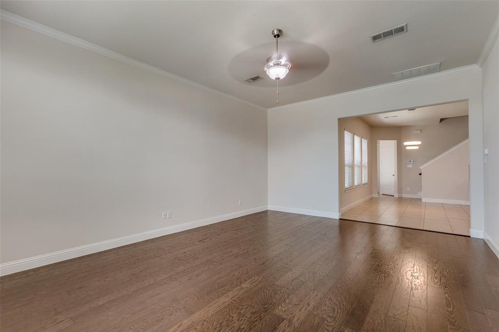 12618 Akenside Road Frisco, TX 75035 - Photo 3 of 31 Spare room with hardwood / wood-style flooring, ornamental molding, and ceiling fan