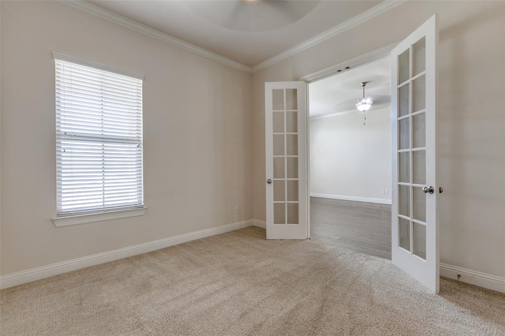 12618 Akenside Road Frisco, TX 75035 - Photo 4 of 31 Carpeted spare room featuring a wealth of natural light, ornamental molding, and french doors