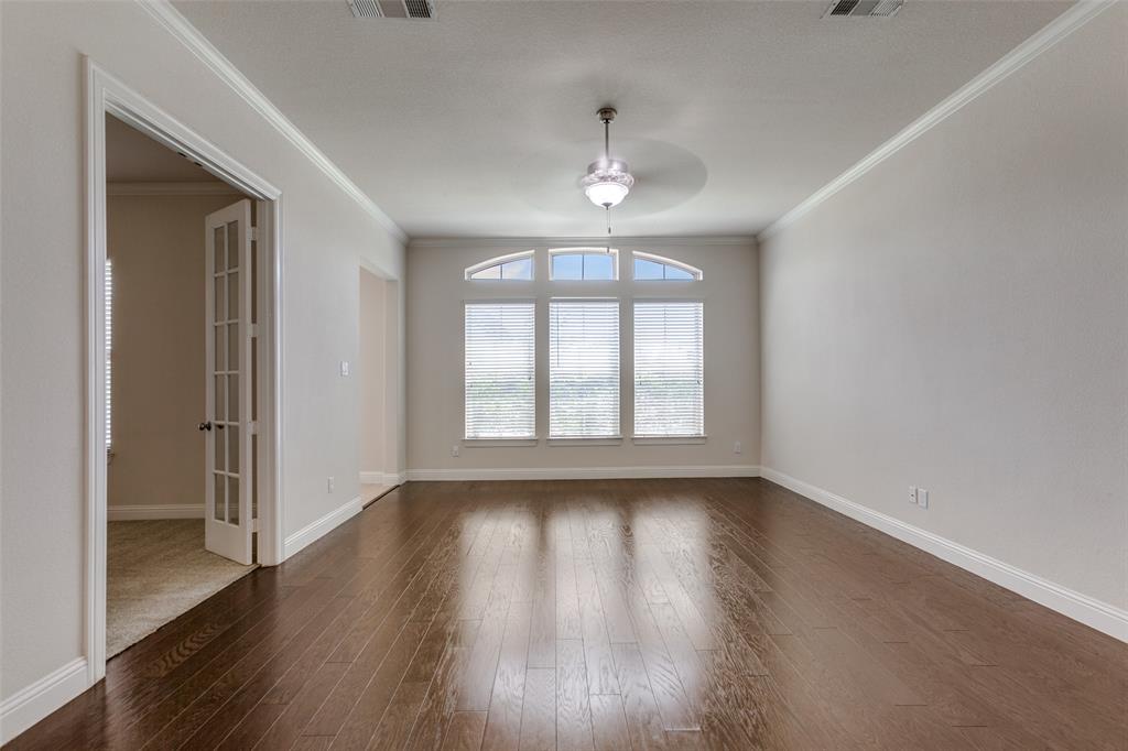 12618 Akenside Road Frisco, TX 75035 - Photo 5 of 31 Empty room with hardwood / wood-style flooring, ornamental molding, and ceiling fan