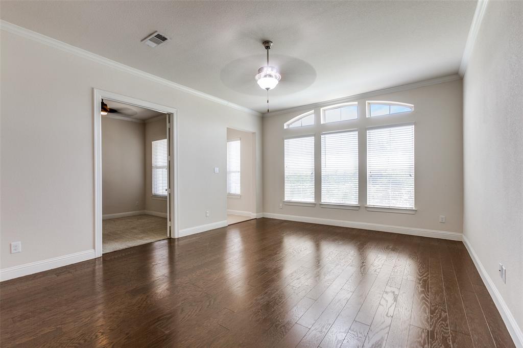 12618 Akenside Road Frisco, TX 75035 - Photo 6 of 31 Unfurnished room featuring ceiling fan, dark wood-type flooring, and ornamental molding