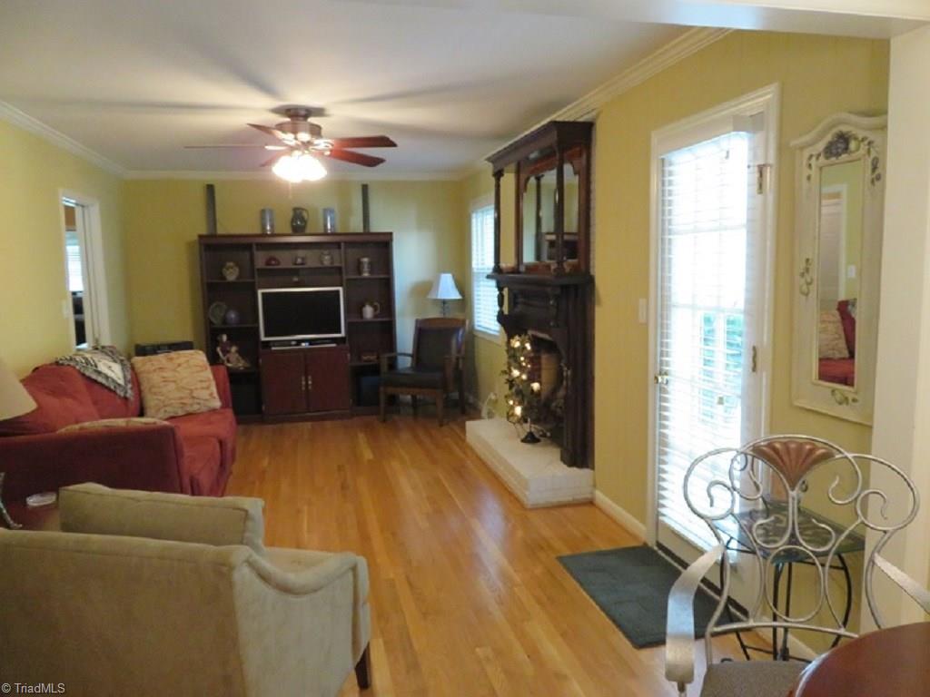221 Pine Ridge Drive High Point, NC 27262 - Photo 12 of 25 Den with woodburning fireplace, smooth ceilings throughout the home. Door to right leads to sunroom