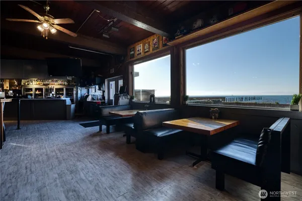 a living room with a table chairs and a window
