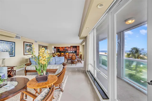 a view of a livingroom with furniture and a large window