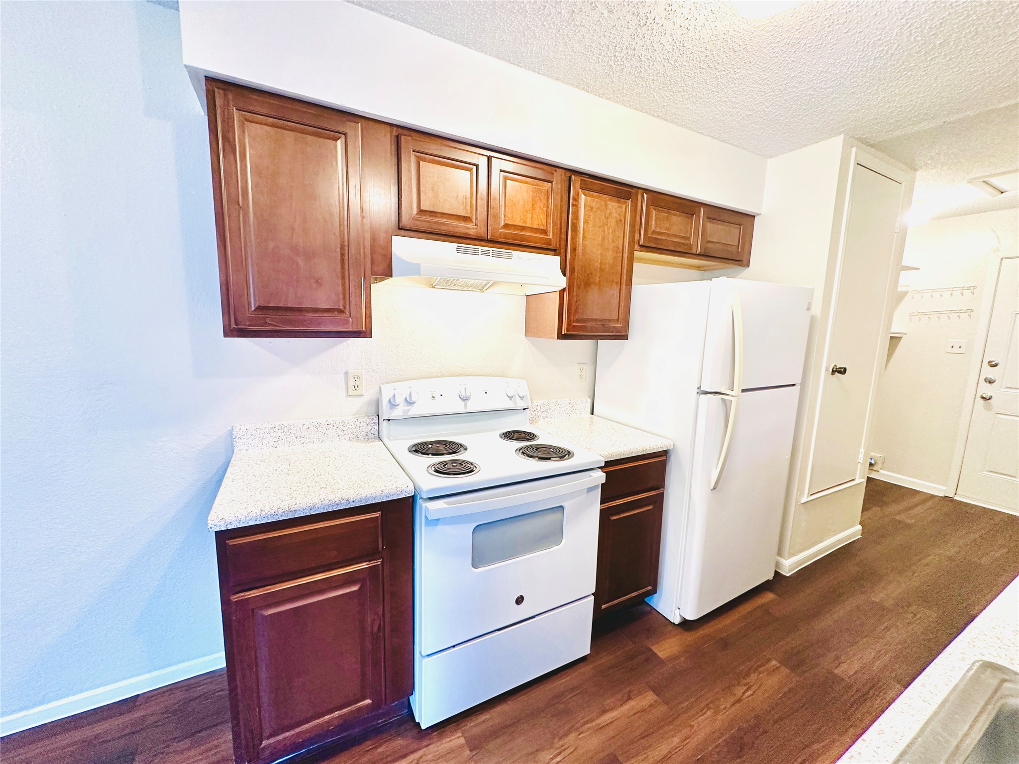 12505 Turtle Rock Road, Unit A Austin, TX 78729 - Photo 3 of 38 A well-appointed kitchen features rich wood cabinetry and ample counter space for culinary endeavors.