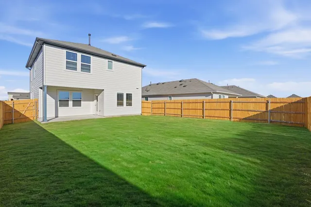 a view of a house with a backyard
