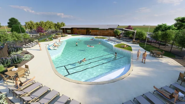 an aerial view of a swimming pool with a yard and outdoor seating