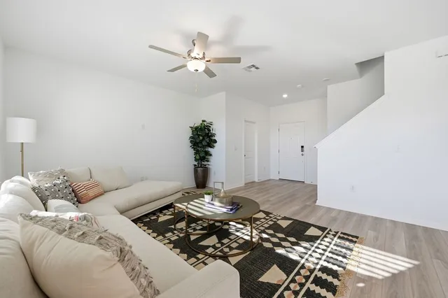 a bedroom with a bed and ceiling fan
