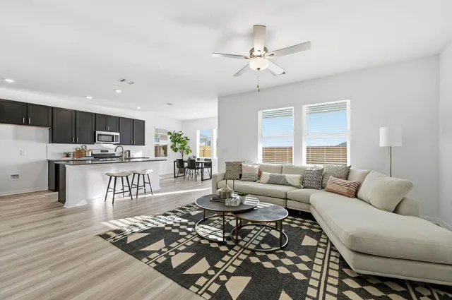 a living room with furniture and kitchen view
