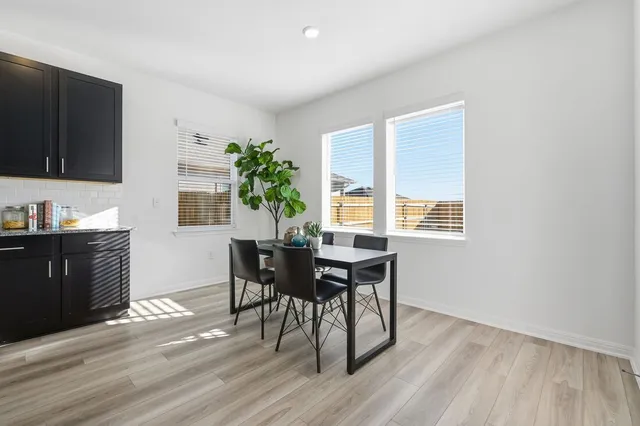 a workspace with furniture window and wooden floor
