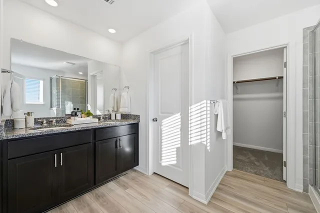 a bathroom with a double vanity sink and mirror