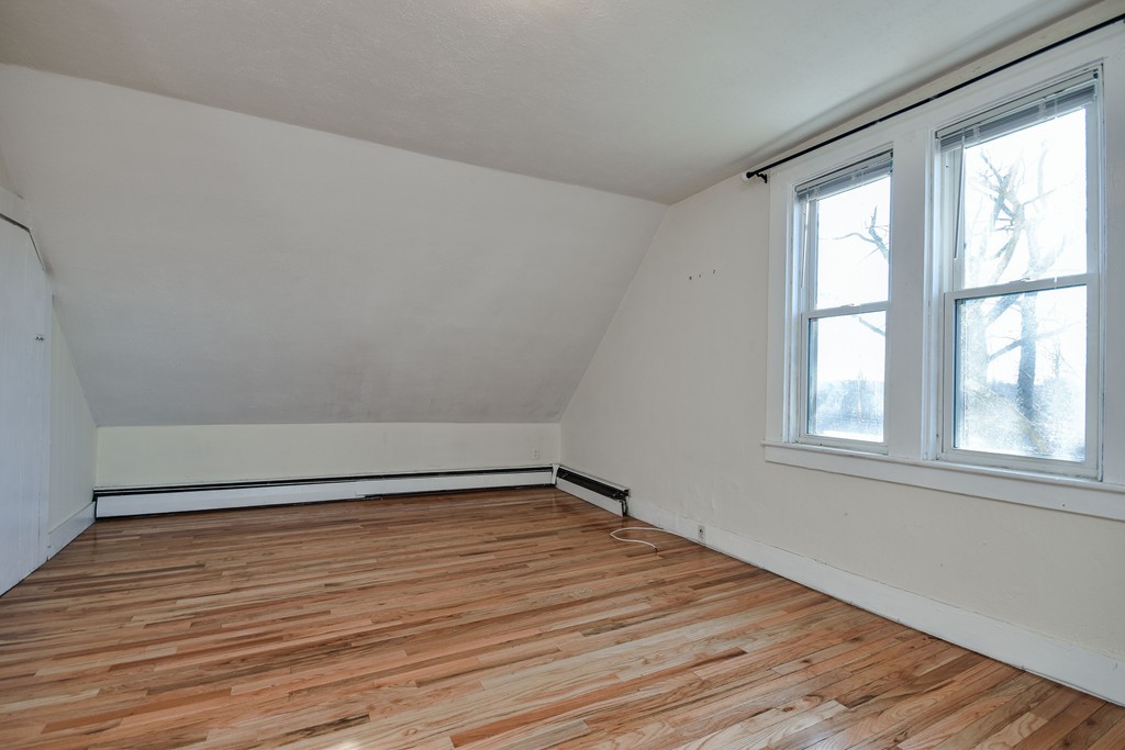 25 North Main Street Natick, MA 01760 - Photo 13 of 16 a view of an empty room with wooden floor and a window