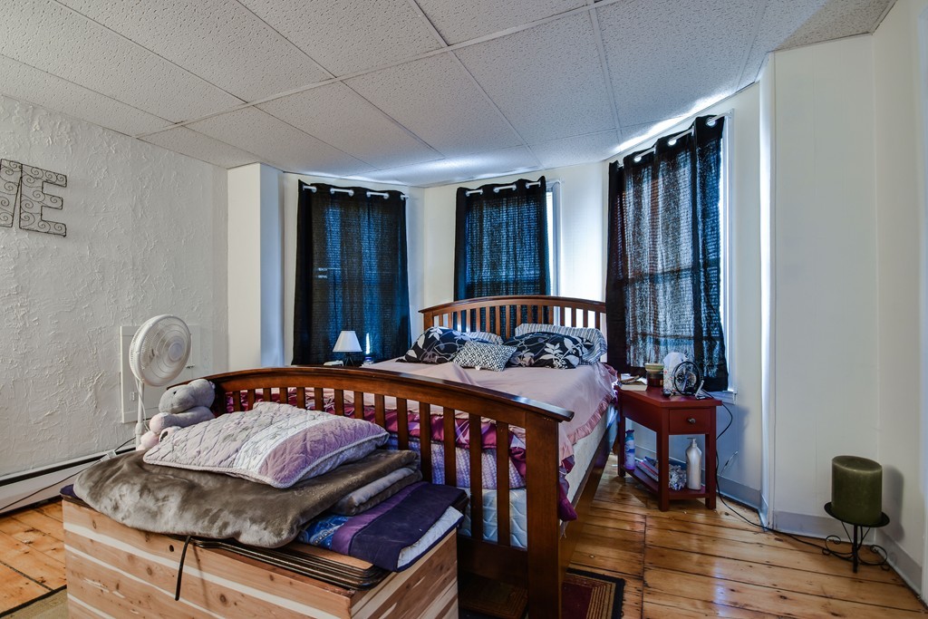 25 North Main Street Natick, MA 01760 - Photo 4 of 16 a bedroom that has a bed and a chair in it