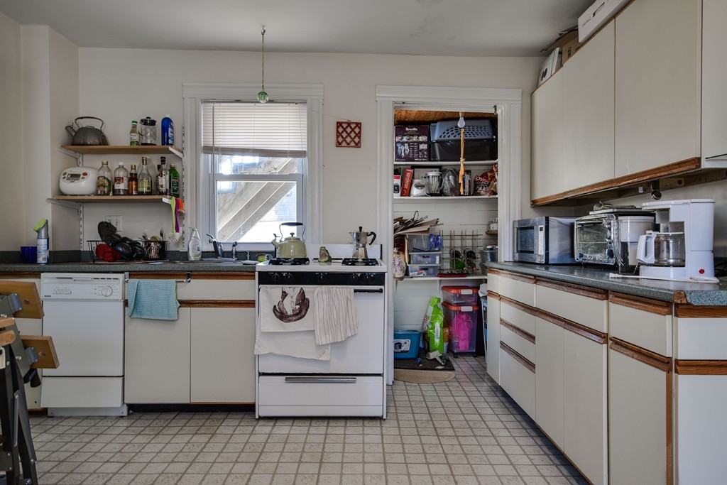 25 North Main Street Natick, MA 01760 - Photo 10 of 16 a kitchen with stainless steel appliances granite countertop a stove and cabinets