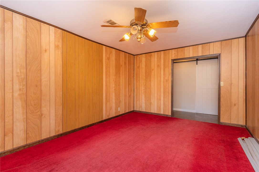 820 Travis Road Anderson, SC 29626 - Photo 27 of 46 This versatile room features warm wood paneling and vibrant flooring, ready for your personal touch.