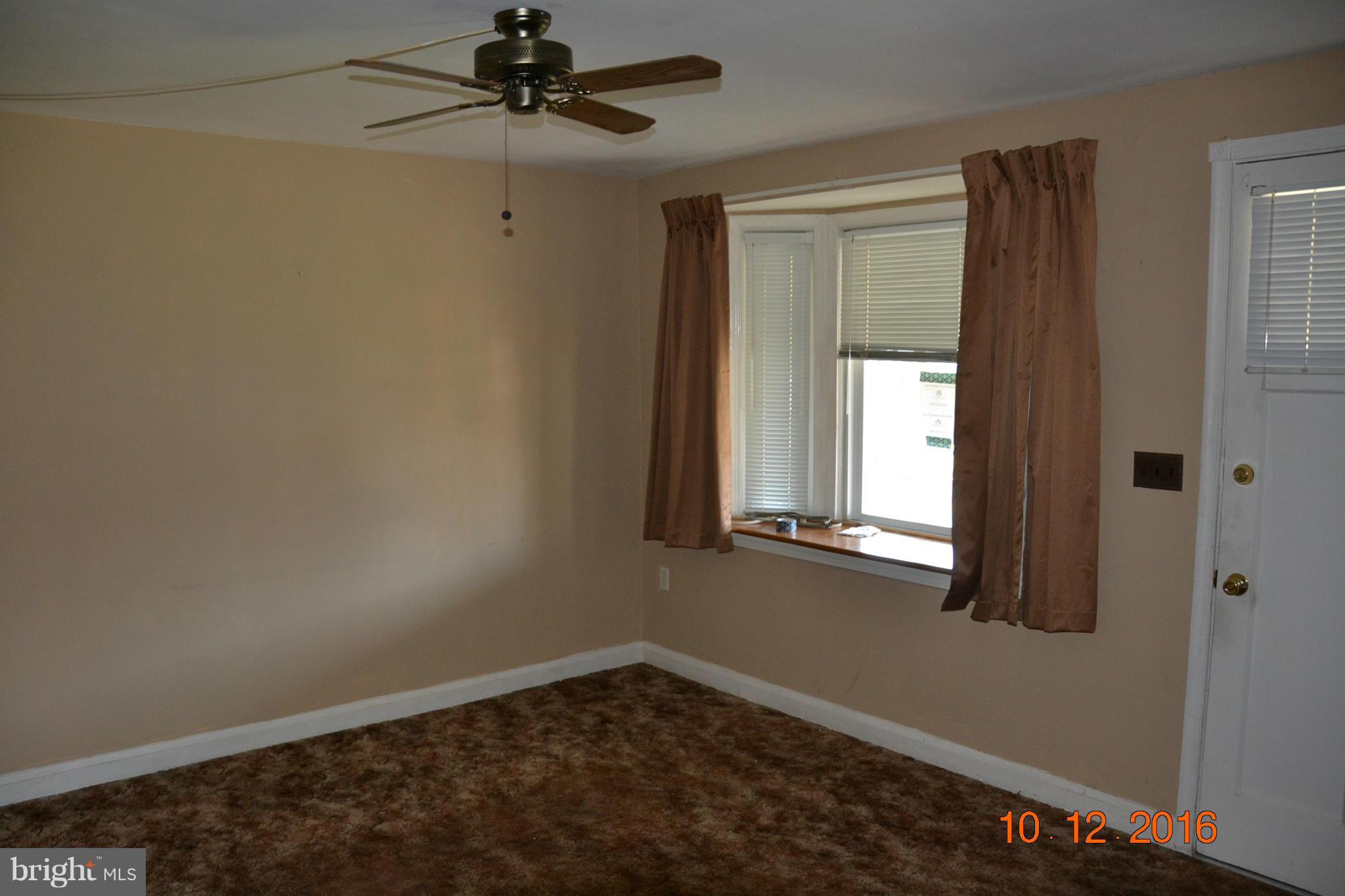 8544 Kavanagh Road Baltimore, MD 21222 - Photo 5 of 14 an empty room with windows and fan