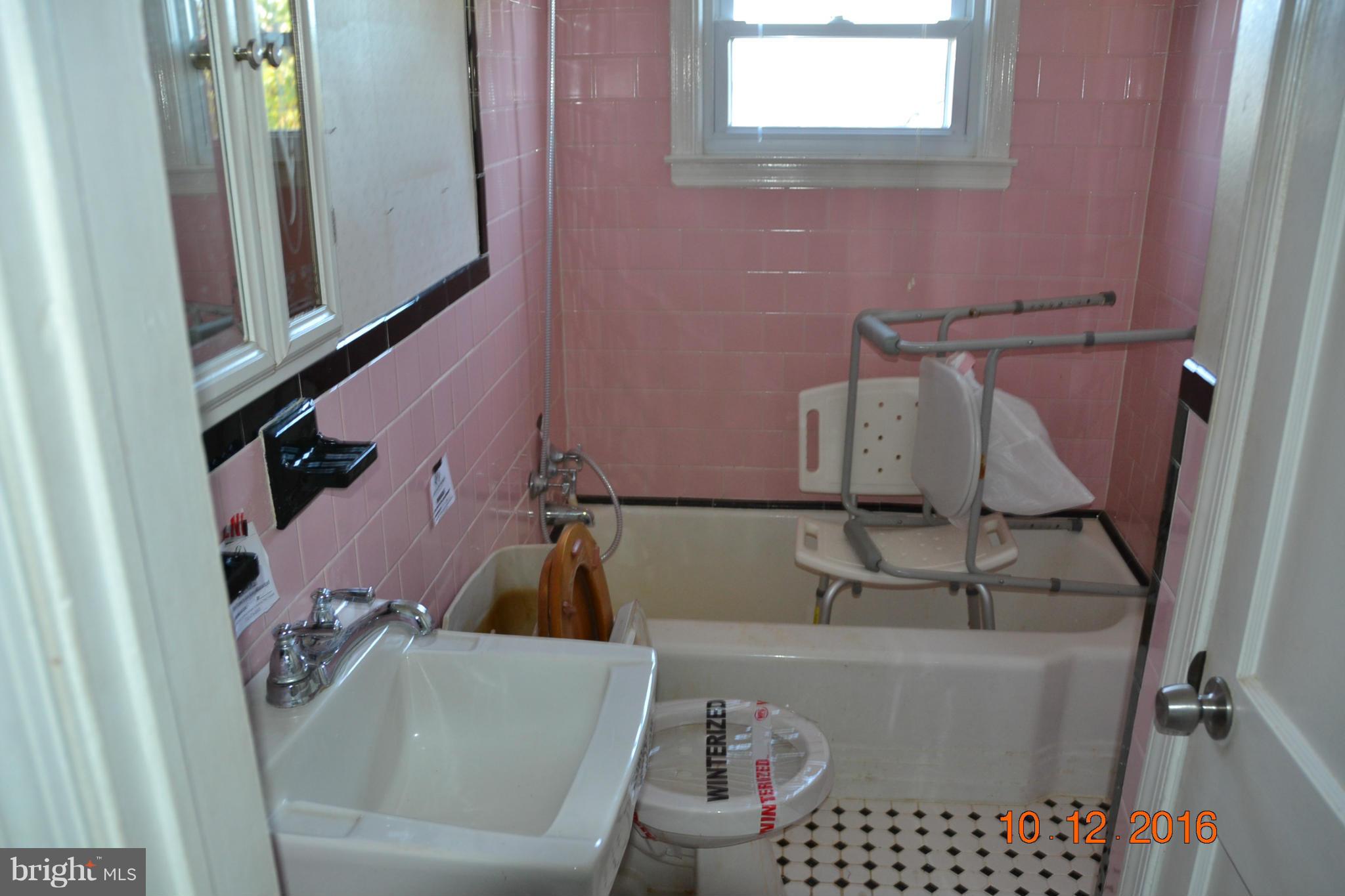 8544 Kavanagh Road Baltimore, MD 21222 - Photo 7 of 14 a bathroom with a sink and a toilet