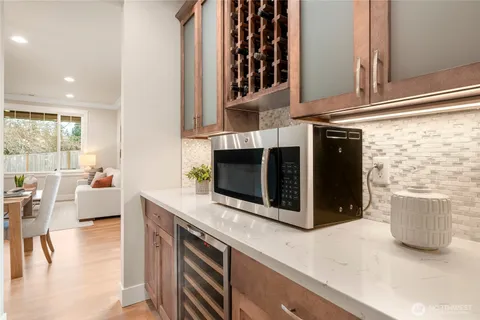 a kitchen with a stove and a white cabinets
