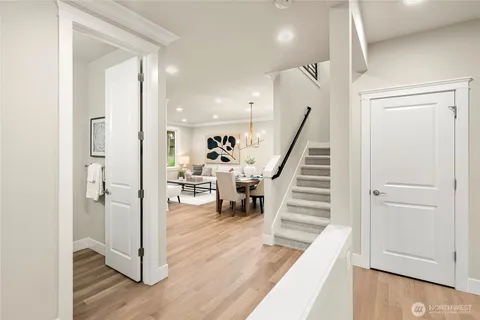 a view of a hallway view with wooden floor and staircase