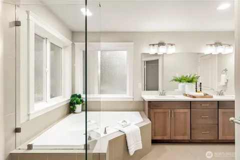 a spacious bathroom with a double vanity sink and a mirror