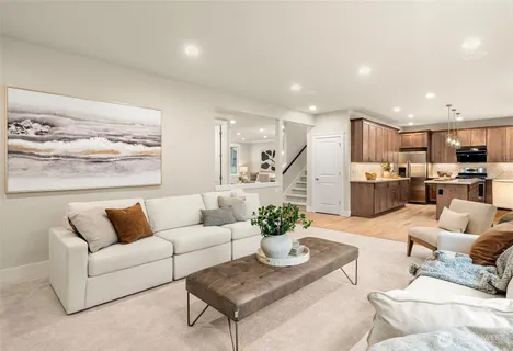 a living room with furniture and kitchen view