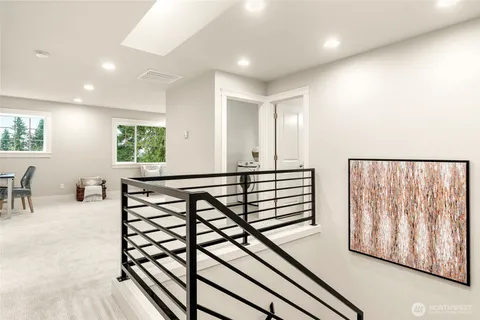 a view of a hallway with wooden floor and furniture