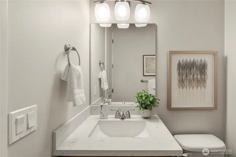a bathroom with a sink vanity and mirror