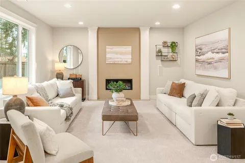 a living room with furniture fireplace and window