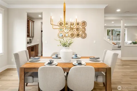 a dining room with furniture and wooden floor