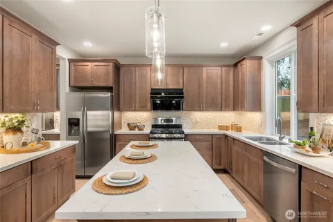 a kitchen with a sink stove and refrigerator