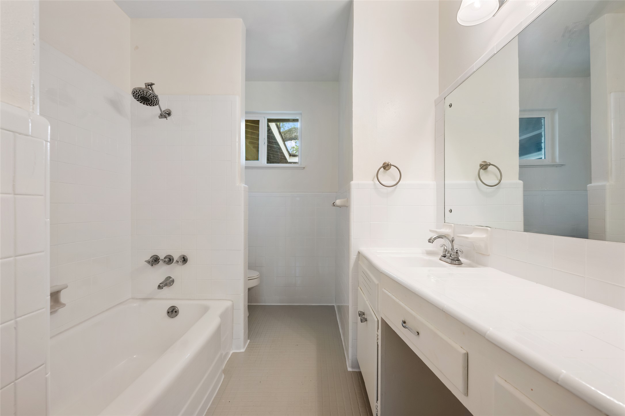 4602 Frontier Trail Austin, TX 78745 - Photo 14 of 21 A well-appointed bath features a tub-shower combination, a vanity with ample counter space, and a separate toilet area.