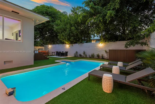 an outdoor sitting area with swimming pool