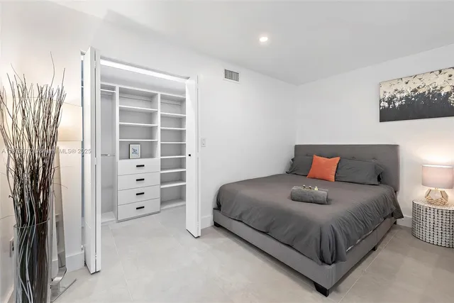 a bedroom with a bed and a walk in closet