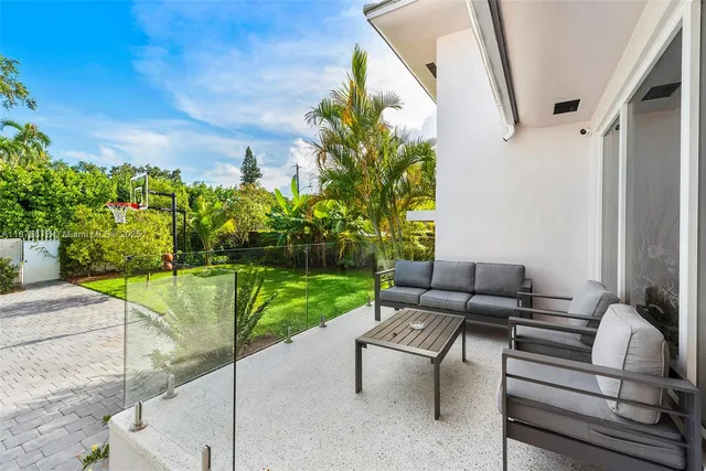 a view of a patio with a table and chairs