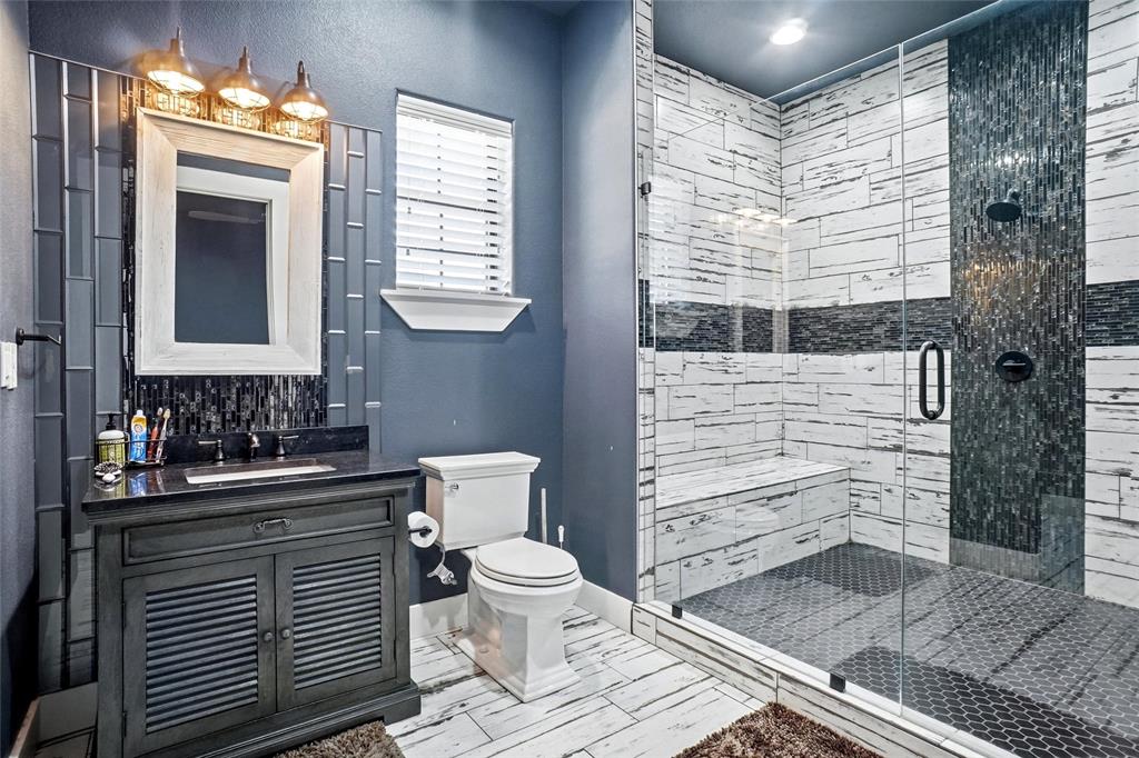 13240 Briar Road Azle, TX 76020 - Photo 32 of 39 a bathroom with a toilet a sink and shower