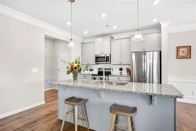 a living room with furniture and kitchen view