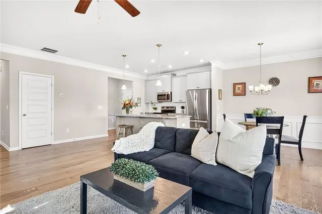 a kitchen with stainless steel appliances granite countertop a sink a oven a stove and a wooden floors