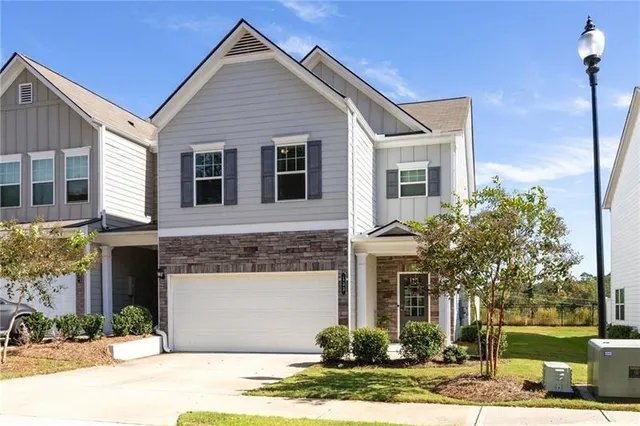 a front view of a house with garden
