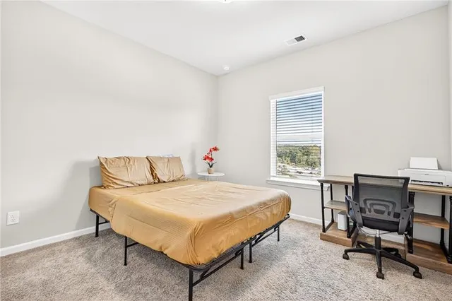 a view of a lake with a yard and a large tree