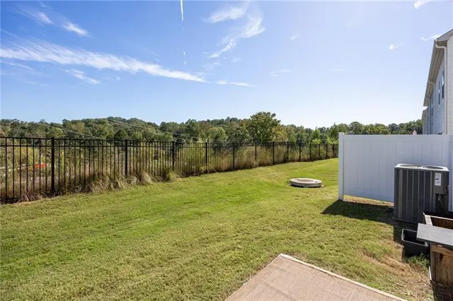 a view of house with yard and furniture